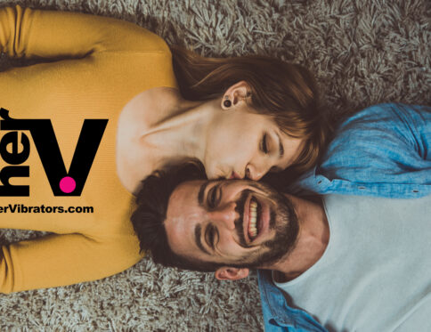 A smiling couple on the floor sharing an intimate moment, representing the lush vibrator experience from hervibrators. Com