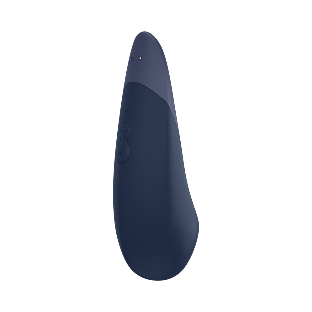 Lifestyle shot featuring the Dark Blue Womanizer vibrator beside the bed