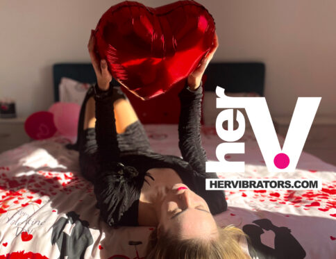 Romantic bedroom with warm lighting, candles, soft textures, and valentine’s day décor creating a sensual atmosphere