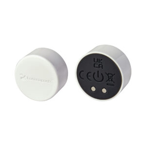 White Black Banana Pants vibrator Puck shown in hand for scale