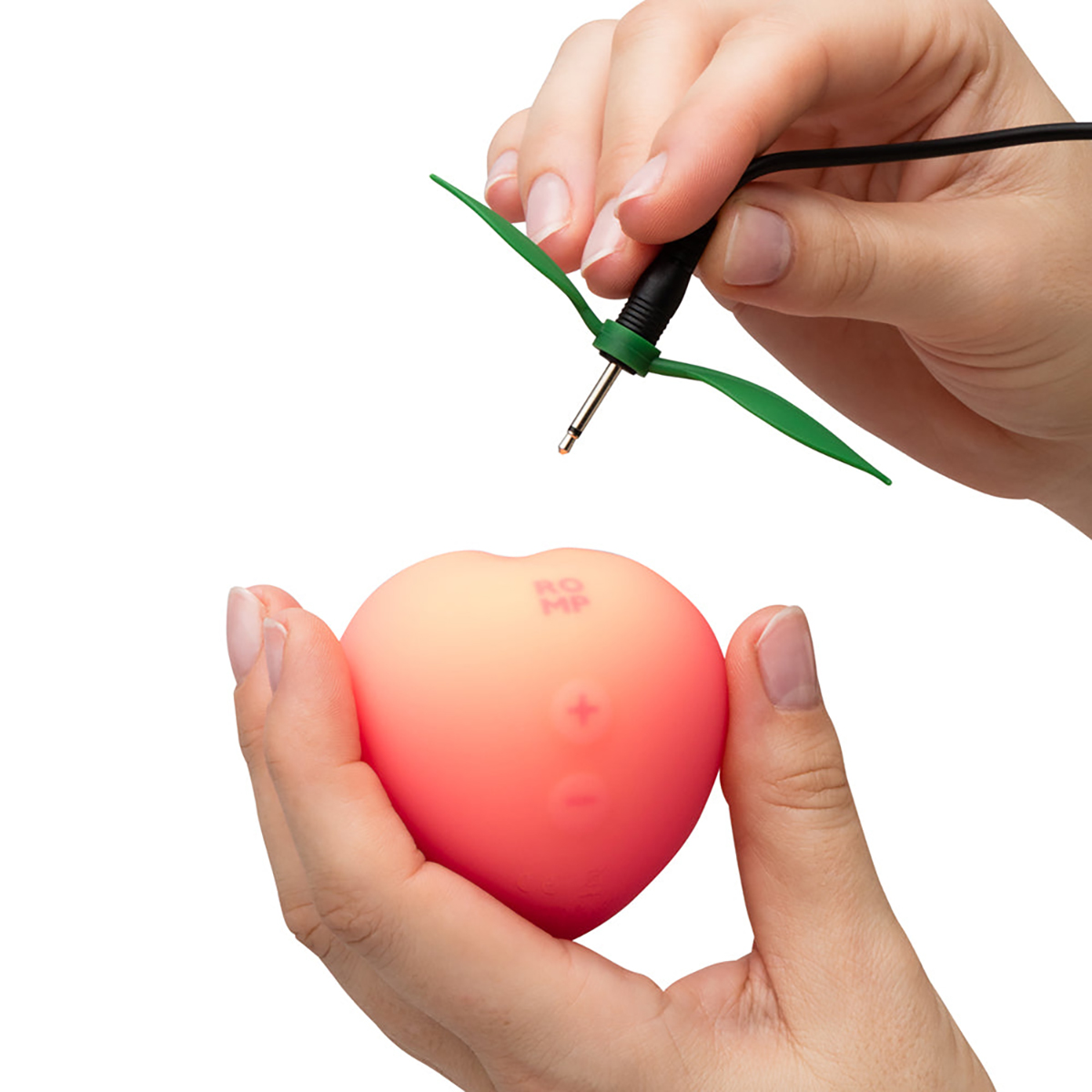Lifestyle shot featuring the Peach ROMP vibrator beside the bed