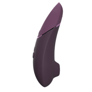 Purple Womanizer vibrator Next Dark shown in hand for scale